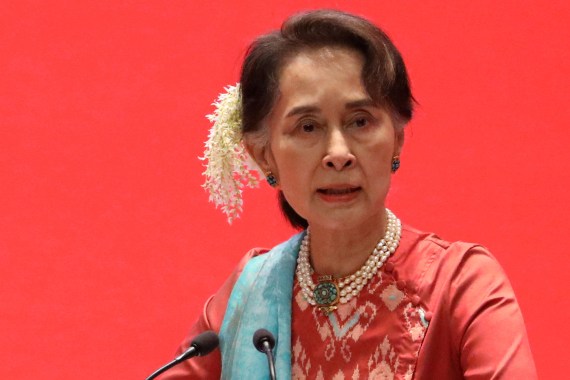 Portrait of Aung San Suu Kyi in red traditional dress with flowers in her hair
