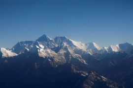 Mount Everest, the world&#39;s highest peak, and other mountains of the Himalayan range are seen through an aircraft window during a 2020 flight from Kathmandu, Nepal [Monika Deupala/Reuters]