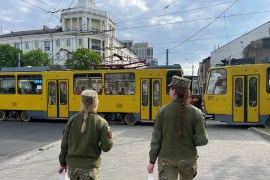 Ukrainian armed servicewomen walk in the street amid Russia's invasion, in Dnipro, Ukraine, May 2, 2022