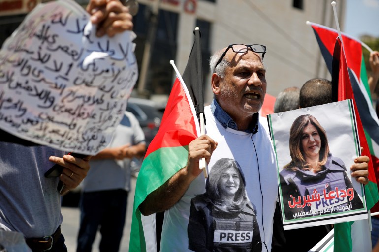 A protestor holds up a picture of slain Palestinian-American journalist Shireen Abu Akleh as Palestinians demonstrate against the visit of U.S. President Joe Biden to Bethlehem, in Dheisheh refugee camp, near Bethlehem in the Israeli-occupied West Bank July 15, 2022.