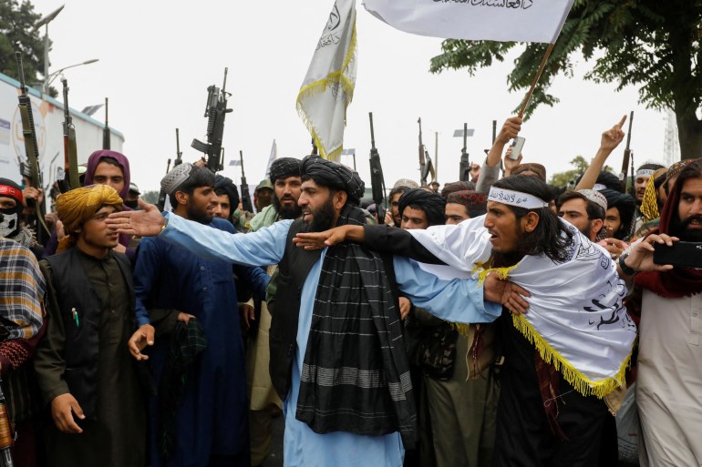 Taliban fighters celebrate the first anniversary of the fall of Kabul on a street in Kabul, Afghanistan, August 15, 2022.