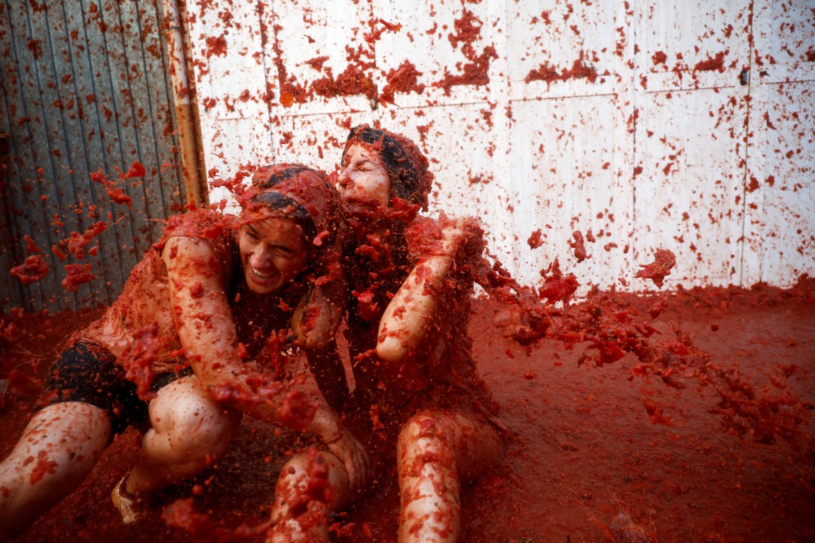 Revelers play in tomato pulp