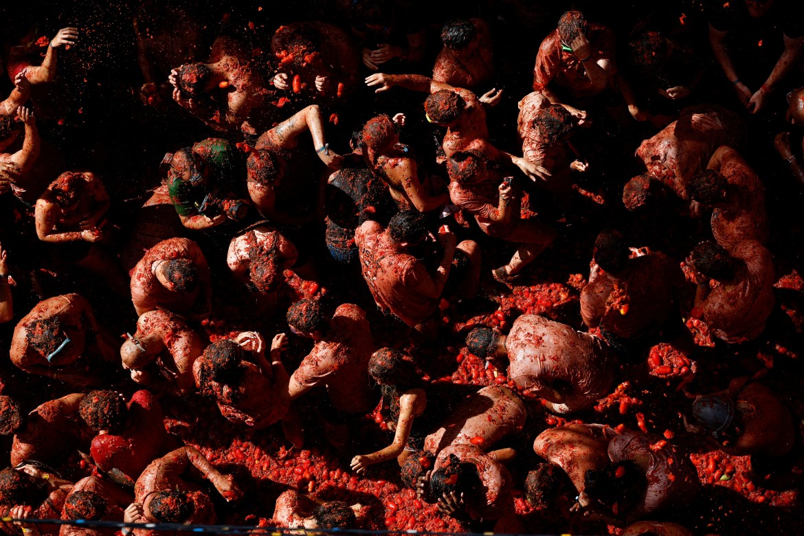Revelers play in tomato pulp
