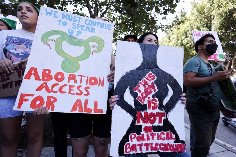 Abortion rights protesters hold signs during a rally in the US