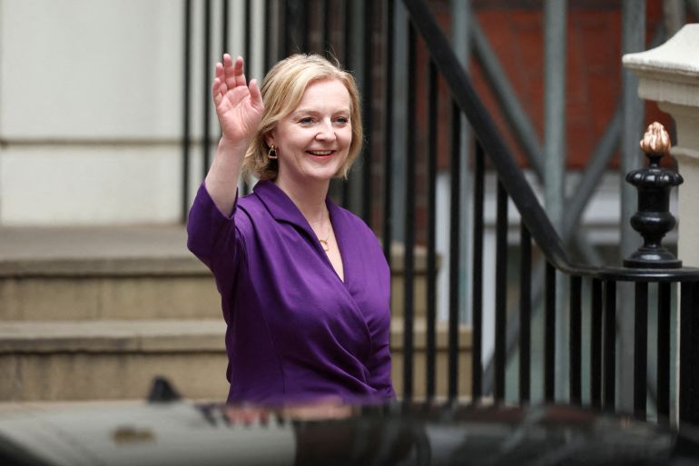 Liz Truss waves as she leaves Conservative Party HQ after being announced as the party's next leader and becoming UK prime minister
