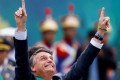 Brazil's President Jair Bolsonaro points to the sky during a rally in Brasilia