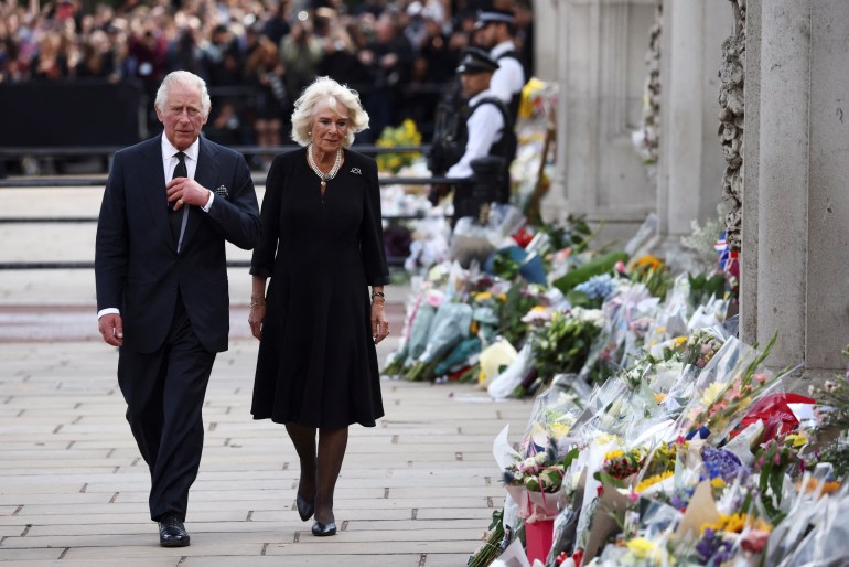 charles and camila inspect floral tributes