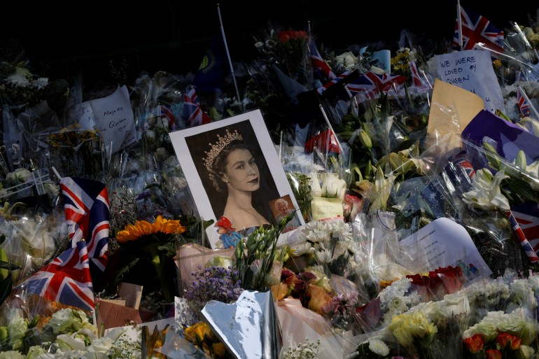 Flowers and pictures of Queen Elizabeth are placed outside the British Consulate-General in Hong Kong