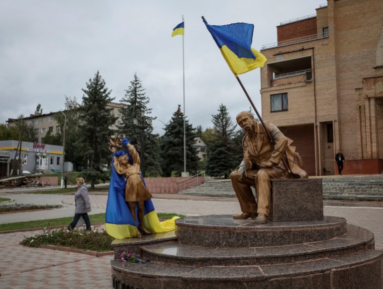 Ukrainian flags flying from the statue of poet Taras Shevchenko in the newly released Balakliia