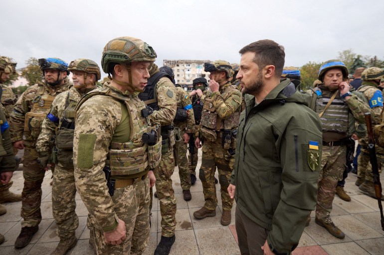 Ukraine's President Volodymyr Zelenskiy speaks with colonel general Oleksandr Syrskyi, Commander of the Ground Forces in the town of Izium recently liberated by the Ukrainian Armed Forces during a counteroffensive operation, amid Russia's attack on Ukrain