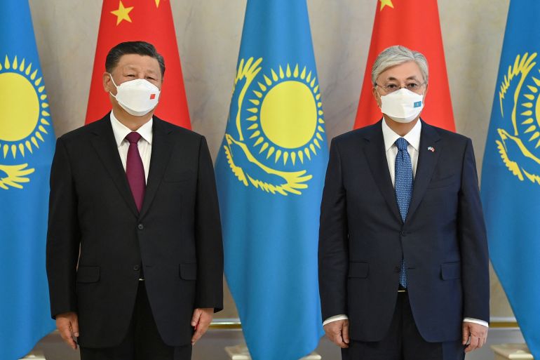 Chinese President Xi Jinping and Kazakh President Kassym-Jomart Tokayev pose for a picture during a meeting in Nur-Sultan