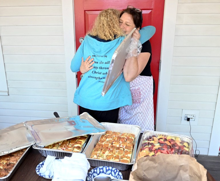 Volunteers hug each other on Martha's Vineyard