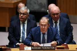 Sergei Lavrov sits at the table in the Security Council with the rest of the Russian delegation behind him
