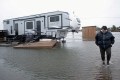 Cathy Simpkins of Moncton walks through flood waters to check her recreational vehicle trailer following the passing of Hurricane Fiona.
