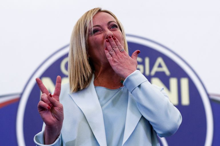 Giorgia Meloni blows kisses to the crowd after making a speech following her party's election victory