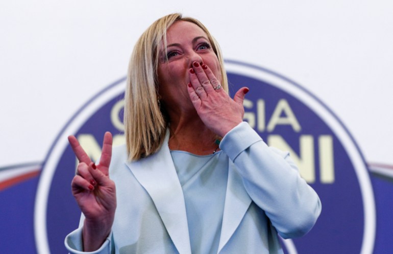 Giorgia Meloni blows kisses to the crowd after making a speech following her party's election victory