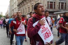A demonstrator joins march in Mexico City to demand justice for 43 missing students