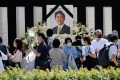 Mourners lay flowers and pay their respects at the altar outside Nippon Budokan Hall, which will host a state funeral for former Prime Minister Shinzo Abe, in Tokyo.