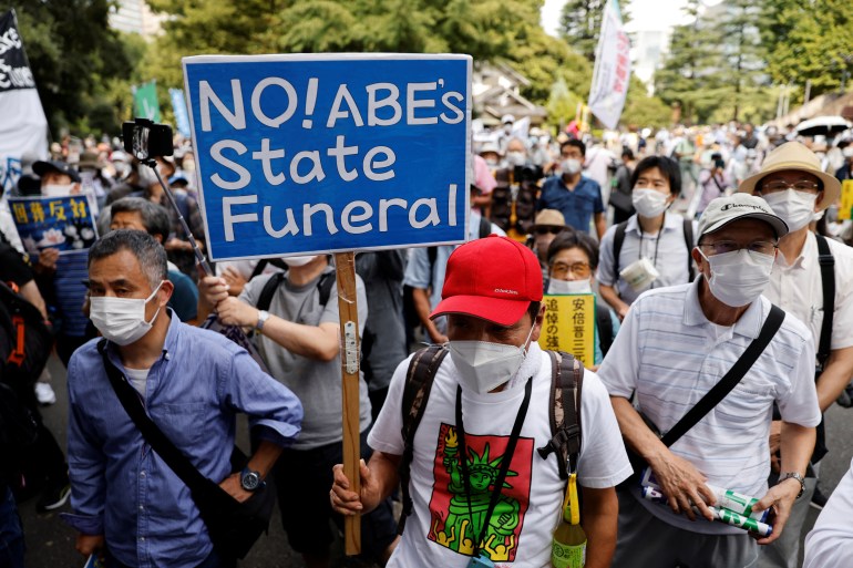 A protester in Tokyo holds up a banner reading 'No! Abe's state funeral' amid opposition to the state funeral in Tokyo
