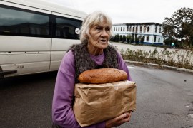 A woman reacts after she received humanitarian aid in the town of Izyum in Ukraine&#39;s Kharkiv region [File: Zohra Bensemra/Reuters]