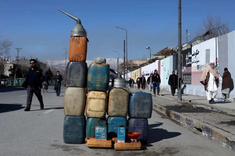 Cans containing gasoline are kept for sale on a road in Kabul, Afghanistan.