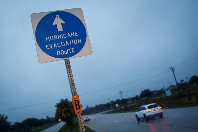 A hurricane evacuation route sign is displayed as Hurricane Ian spins toward the state carrying high winds, torrential rains and a powerful storm surge, in Punta Gorda, Florida, U.S. September 27, 2022. REUTERS/Marco Bello