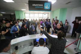 Russian citizens visit a public service centre to receive an individual identification number for foreigners in the city of Almaty, Kazakhstan [Pavel Mikheyev/Reuters]