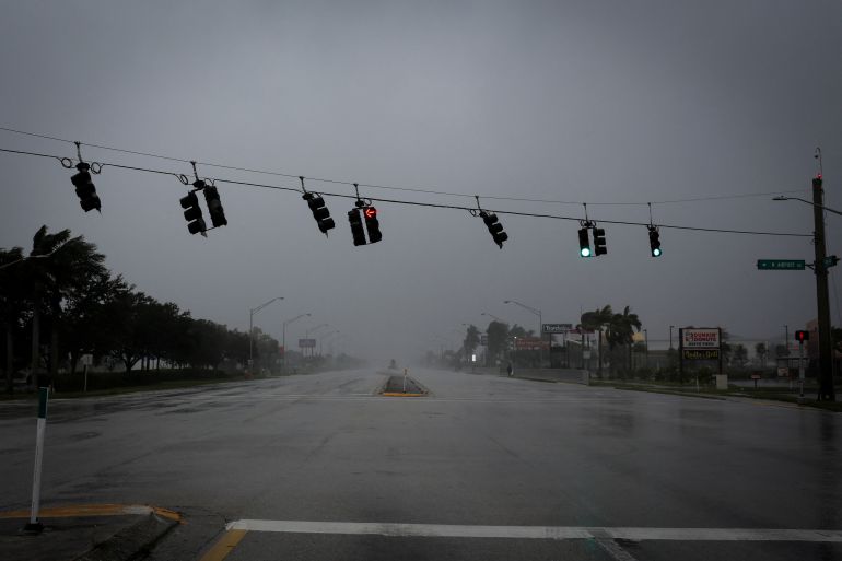 Traffic lights wave in wind as Hurricane Ian hits Florida