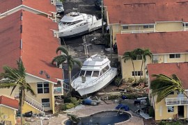 Damaged boats thrown between houses in Fort Myers by Hurricane Ian