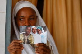 Widow Khadiatou Barry displays a wedding photograph showing her husband Alpha Oumar Diallo, who was killed on September 28, 2009 when security forces fired on pro-democracy demonstrators at a stadium in Guinea's capital Conakry [File: Rebecca Blackwell/AP]