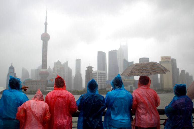 Shanghai city's famous skyscrapers across the Huangpu River in heavy rain and strong wind in 2011 [File: Eugene Hoshiko/AP]