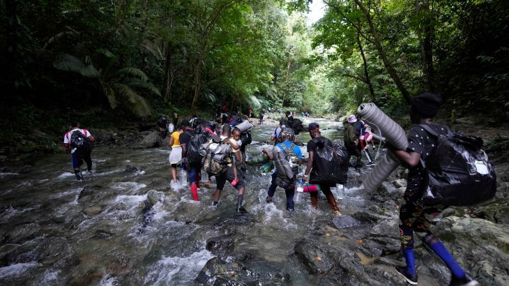 Refugees and migrants cross the Acandi River on their journey north, near Acandi, Colombia.