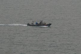 A Lebanese navy vessel searches for people from a migrant boat
