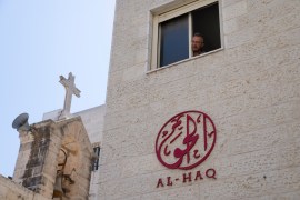 A man looks out of the window of the office of al-Haq, a Palestinian human rights organisation in the West Bank city of Ramallah on Aug. 18, 2022. The group is among seven that Israeli authorities are trying to close down, accusing them of ties to militants — even though international funders have found no evidence to back those claims.