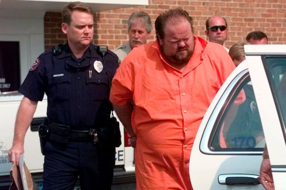 Officials escort murder suspect Alan Eugene Miller away from the Pelham City Jail in Ala., on August 5, 1999