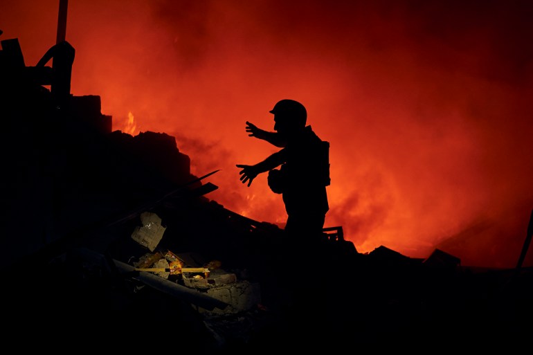 A Ukrainian State Emergency Service firefighter works after a rocket attack in Kramatorsk, eastern Ukraine, Saturday, Aug. 3, 2022. (AP Photo/Kostiantyn Liberov)