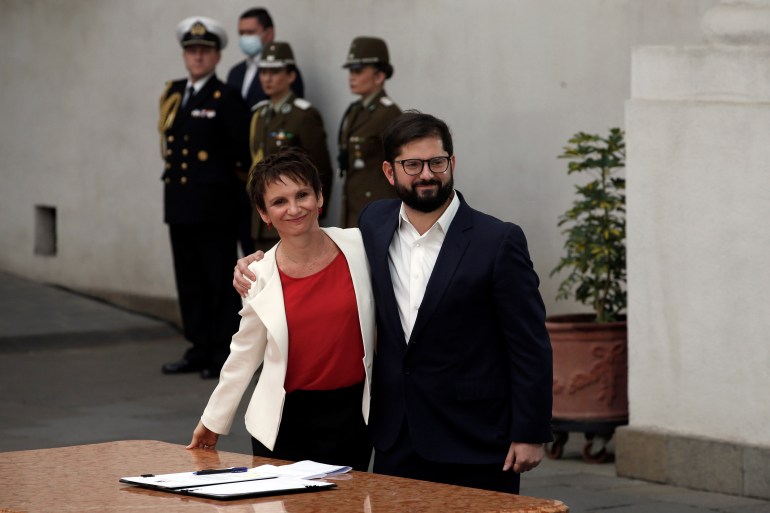 Boric poses with new Interior Minister Carolina Toha at the La Moneda presidential palace in Santiago, Chile.