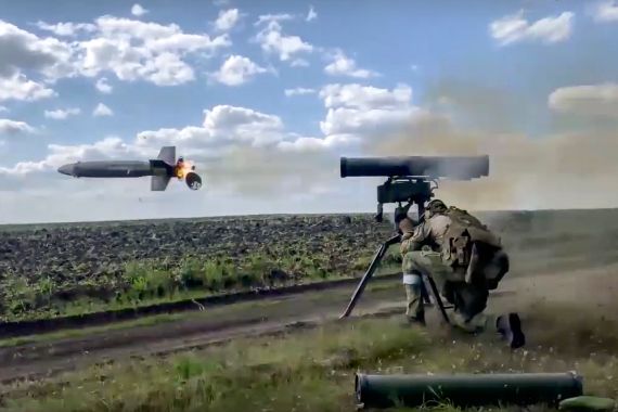 A Russian soldier fires from a Kornet, a Russian portable anti-tank guided missile on a mission at an undisclosed location in Ukraine.