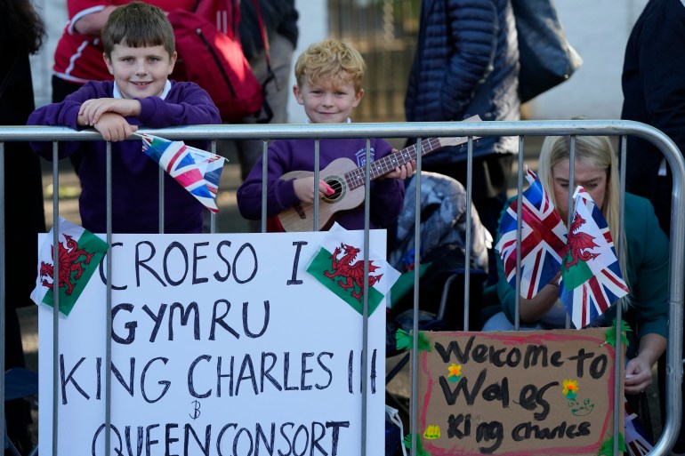 Children wait for the arrival of King Charles III and the Queen in Cardiff, Wales, Friday, September 16, 2022. The Royal couple will visit Wales for the first time since the death of Queen Elizabeth II