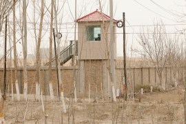 A security guard watches from a tower around a detention facility in Yarkent County in northwestern China's Xinjiang.