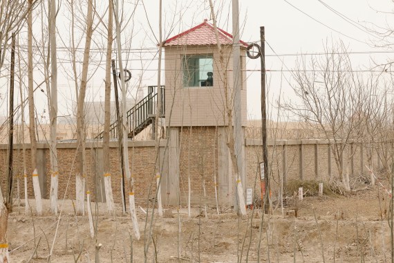 A security guard watches from a tower around a detention facility in Yarkent County in northwestern China's Xinjiang.