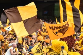 Hawthorn Hawks fans wave flags during the Australian Football League Grand Final between the Hawks and the West Coast Eagles