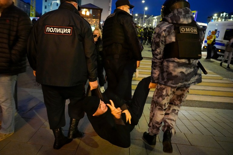 A demonstrator being detained.