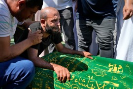 A mourner reacts by the coffin of Palestinian Abdul-Al Omar Abdul-Al in Tripoli.