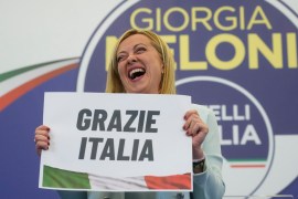 Far-right party Brothers of Italy&#39;s leader Giorgia Meloni shows a placard thanking Italian voters after emerging the biggest winner — and likely next prime minister — in last Sunday&#39;s election [Gregorio Borgia/AP Photo]