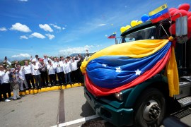 A Venezuelan cargo truck adorned with Venezuelan flags and balloons crosses the Simon Bolivar International Bridge into Colombia