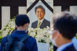 People leave flowers and pay their respects to former Japanese Prime Minister Shinzo Abe