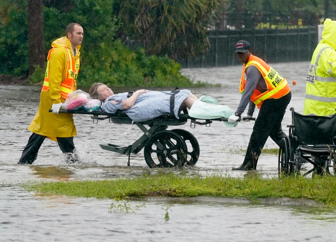 Authorities transport a person out of the Avante nursing home in the aftermath of Hurricane Ian