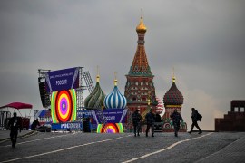 Police officers walk at Red Square in front of constructions reading the words &#39;Donetsk, Luhansk, Zaporizhzhia, Kherson, Russia&#39;, with the St. Basil&#39;s Cathedral and Lenin Mausoleum in the background, ahead of a planned concert in Moscow [Alexander Zemlianichenko/AP]