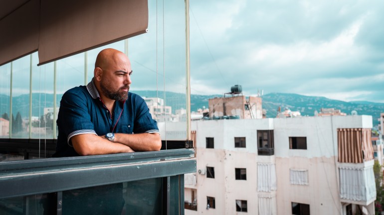 Ibraheem Abdallah stares out at the Beirut skyline from his balcony